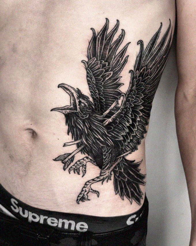 Raven's Flight Inked Across a Torso