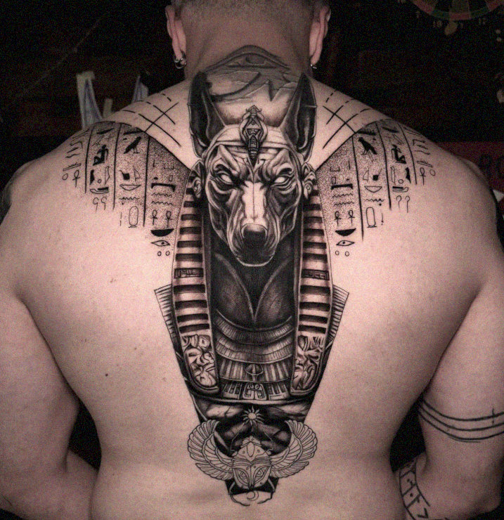 Anubis Tattoo Traced in Hieroglyphic Scrolls