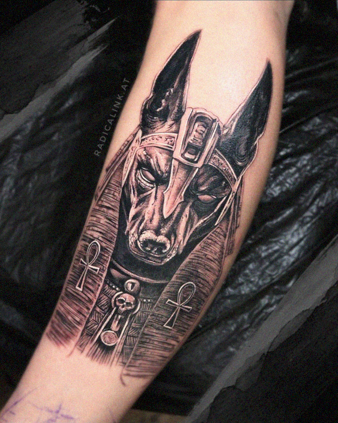 Anubis Mask Tattoo Embraces Human Arm