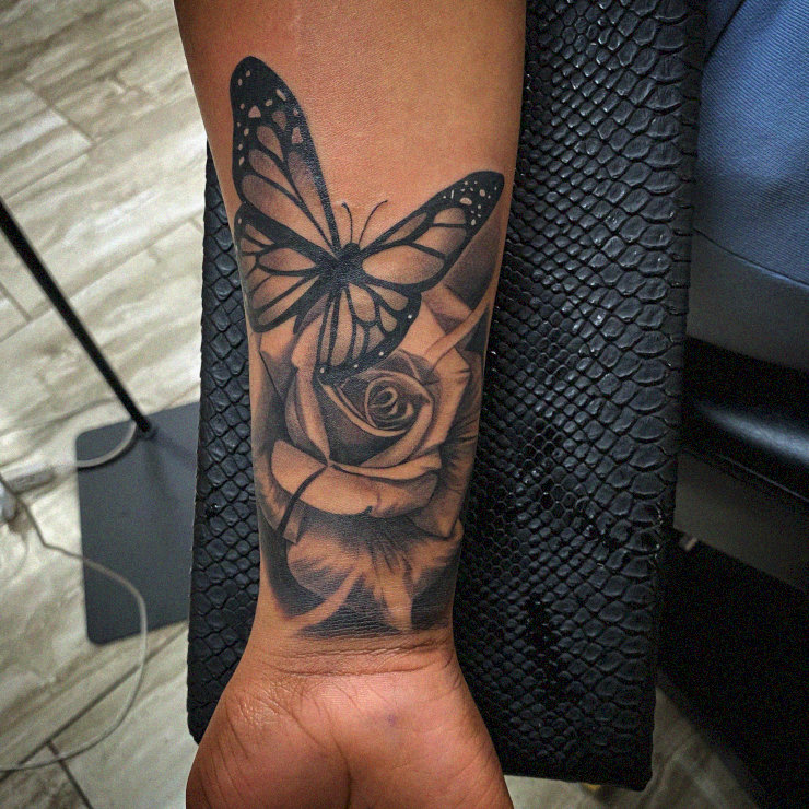 Butterfly on Rose: A Monochrome Tattoo Tale