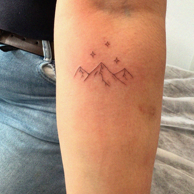 Mountain Range Tattoo Twinkling with Stars